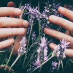 hands with purple flowers